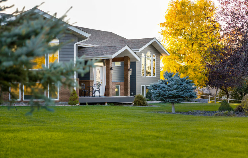 Beautiful multi-story home with lawn and vibrant autumn trees in Blacksburg, Virginia.